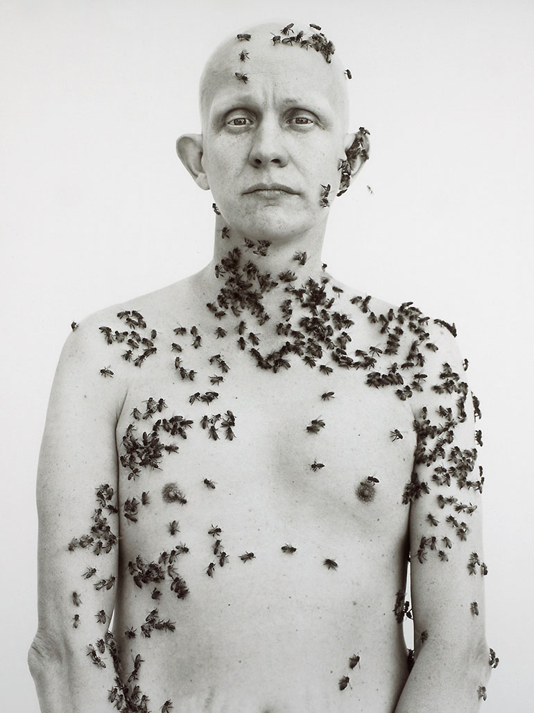 a man covered in bees